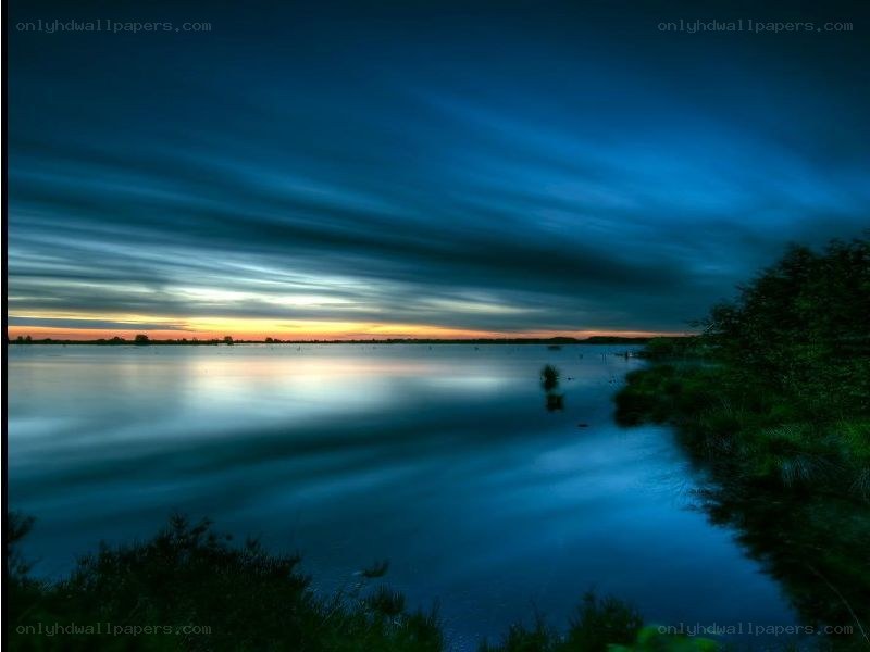 Blue sunset over calm lake