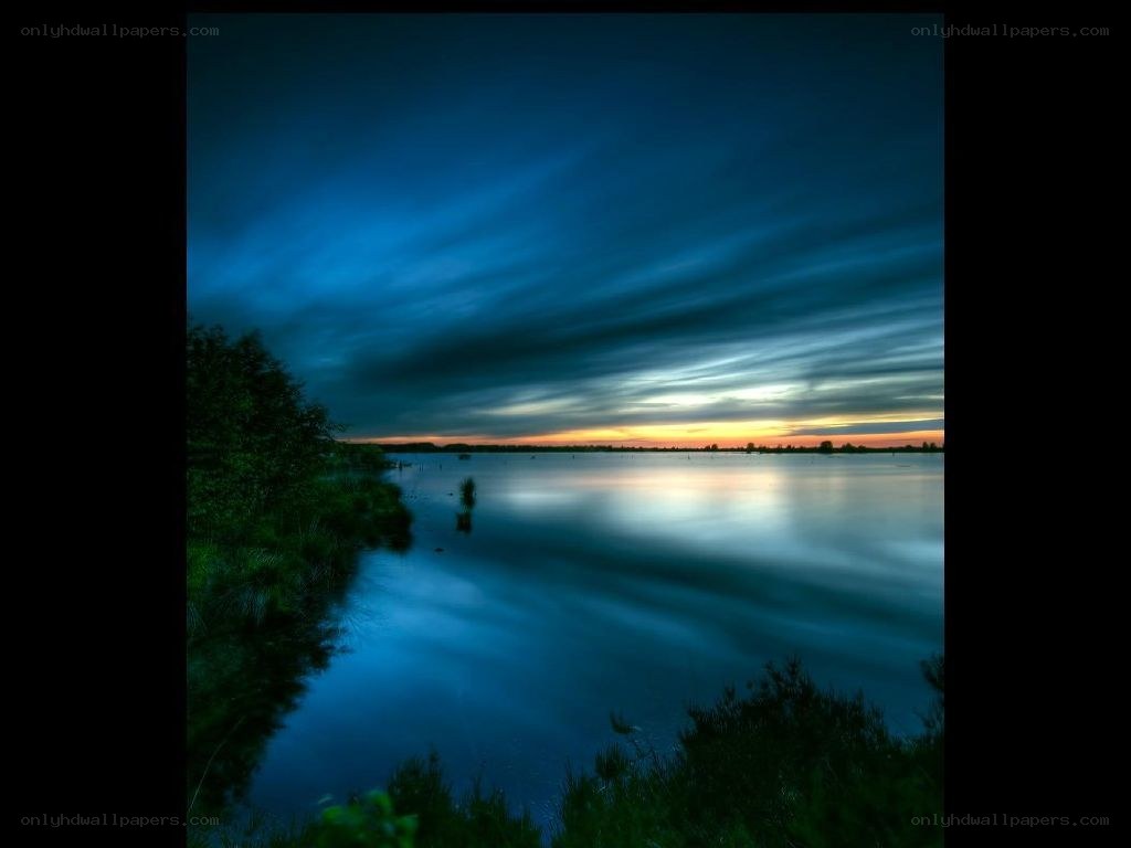 Blue sunset over calm lake