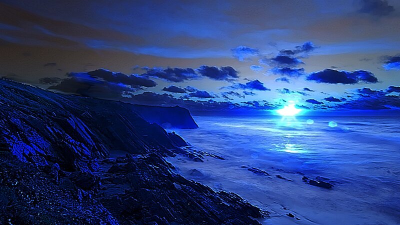 Blue sunset over rocky coast
