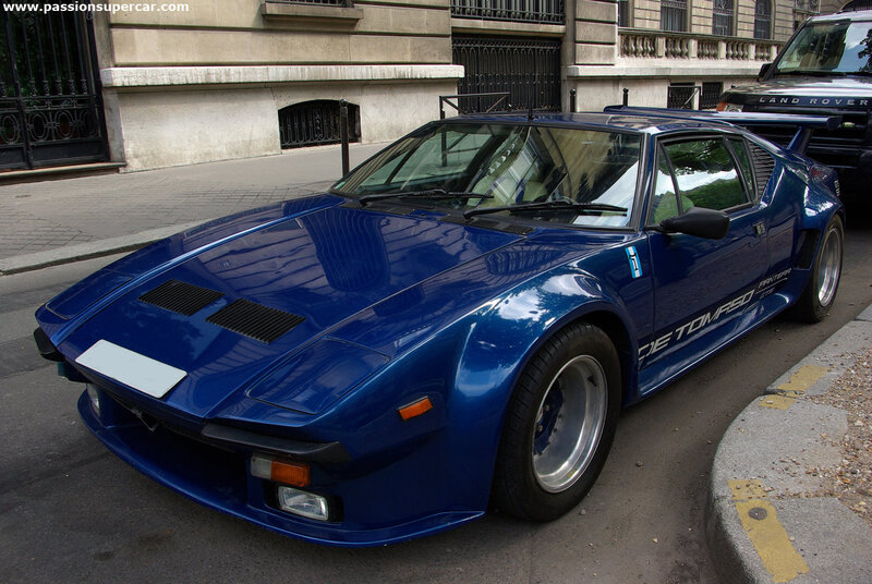 blue supercar on city street