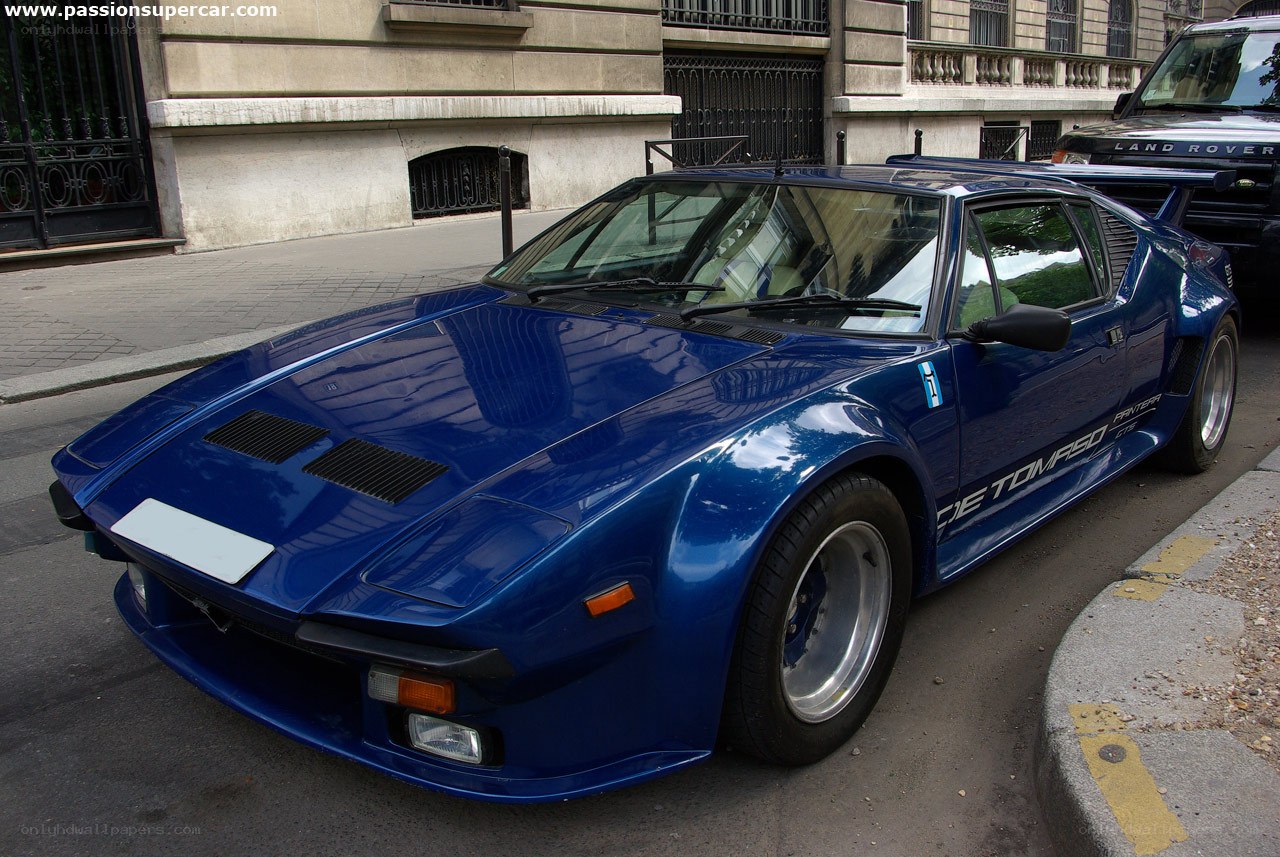 blue supercar on city street