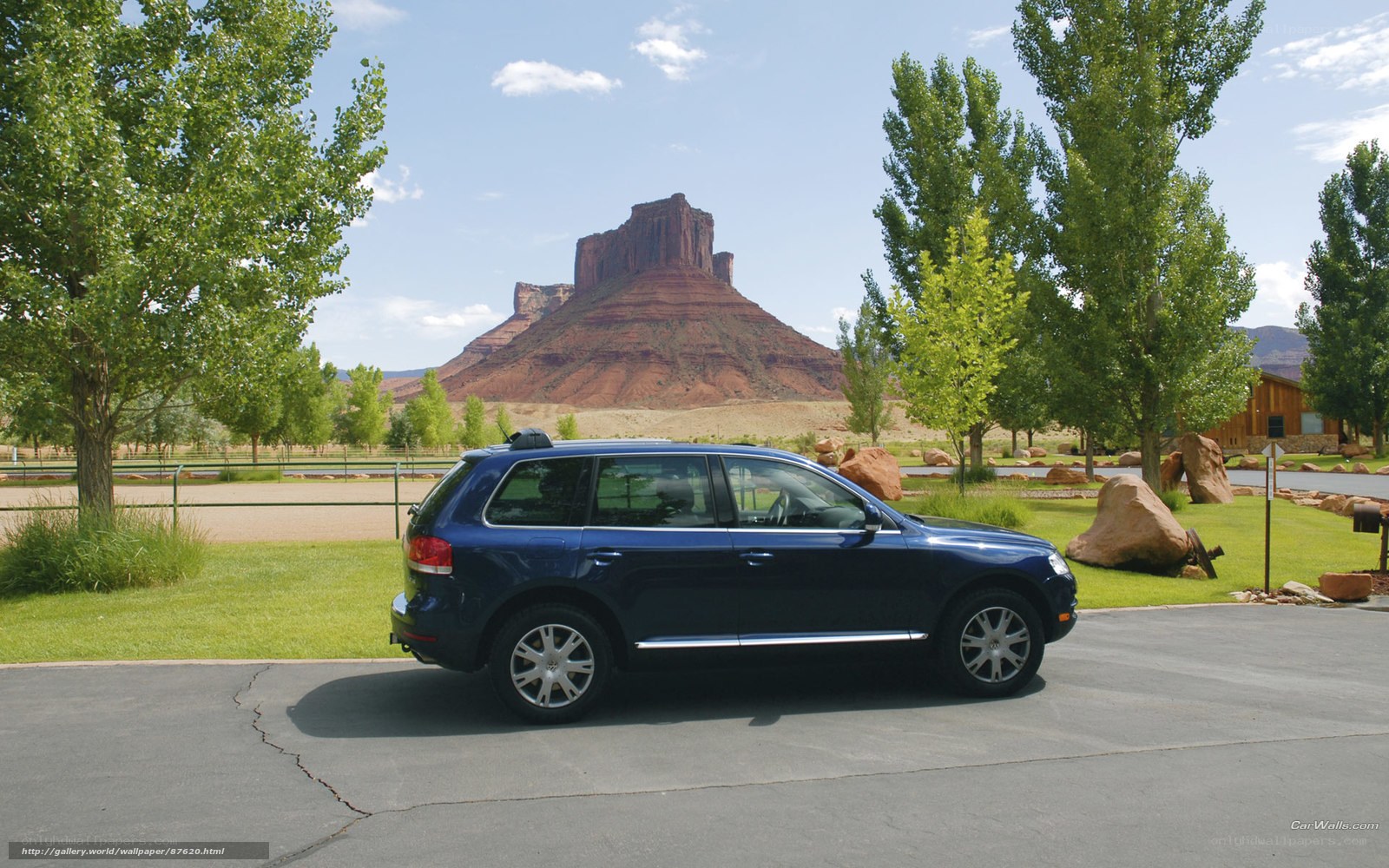 Blue SUV in desert landscape
