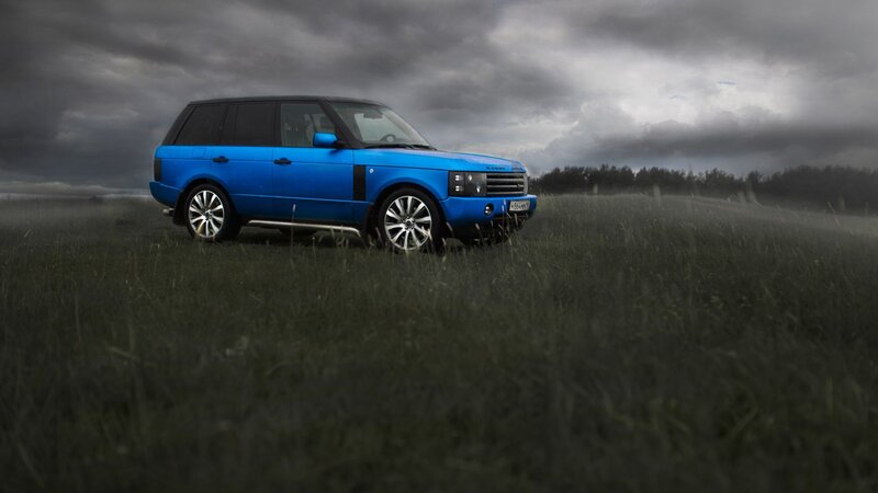 Blue SUV in Field