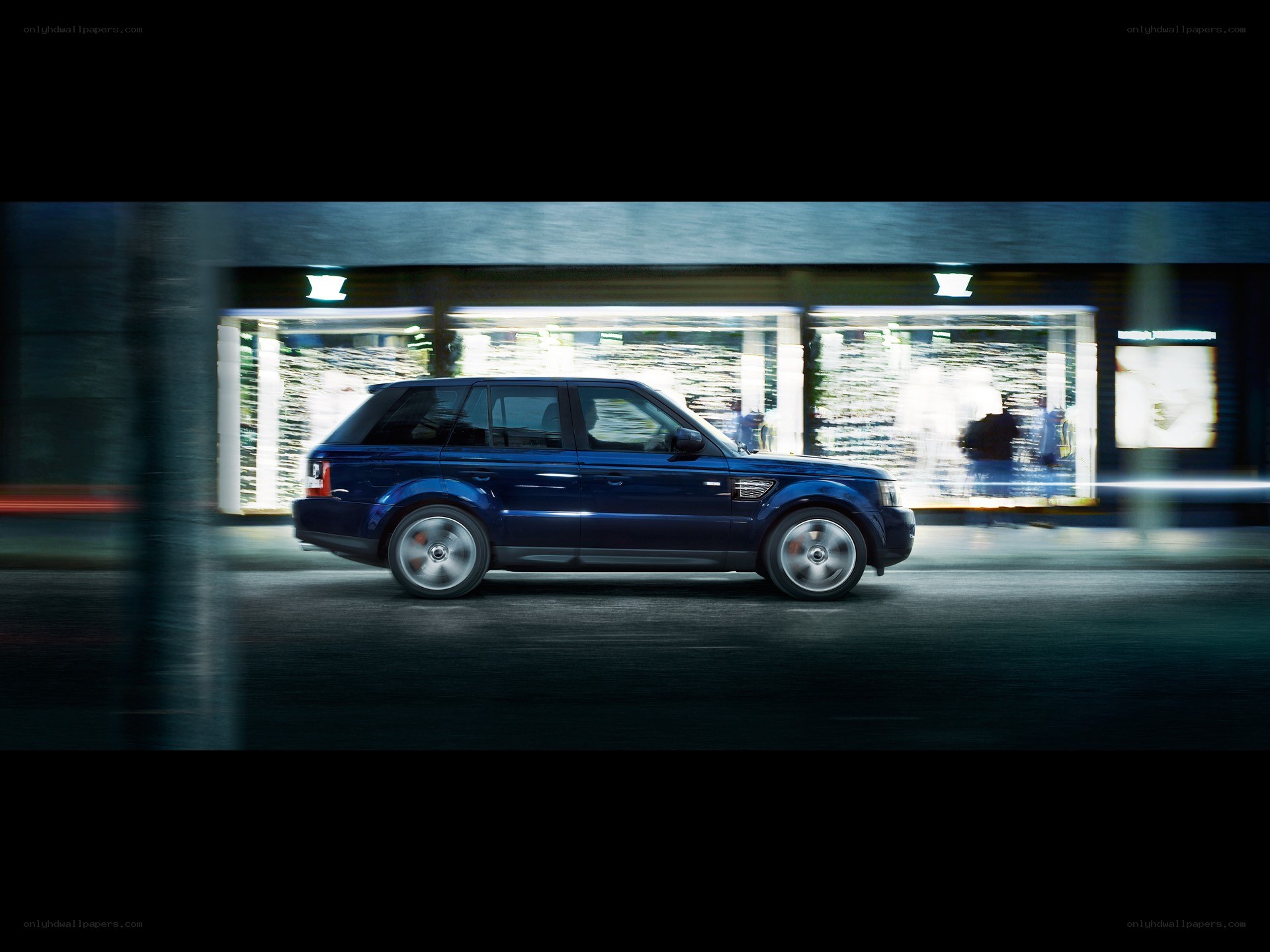 blue suv in motion at night