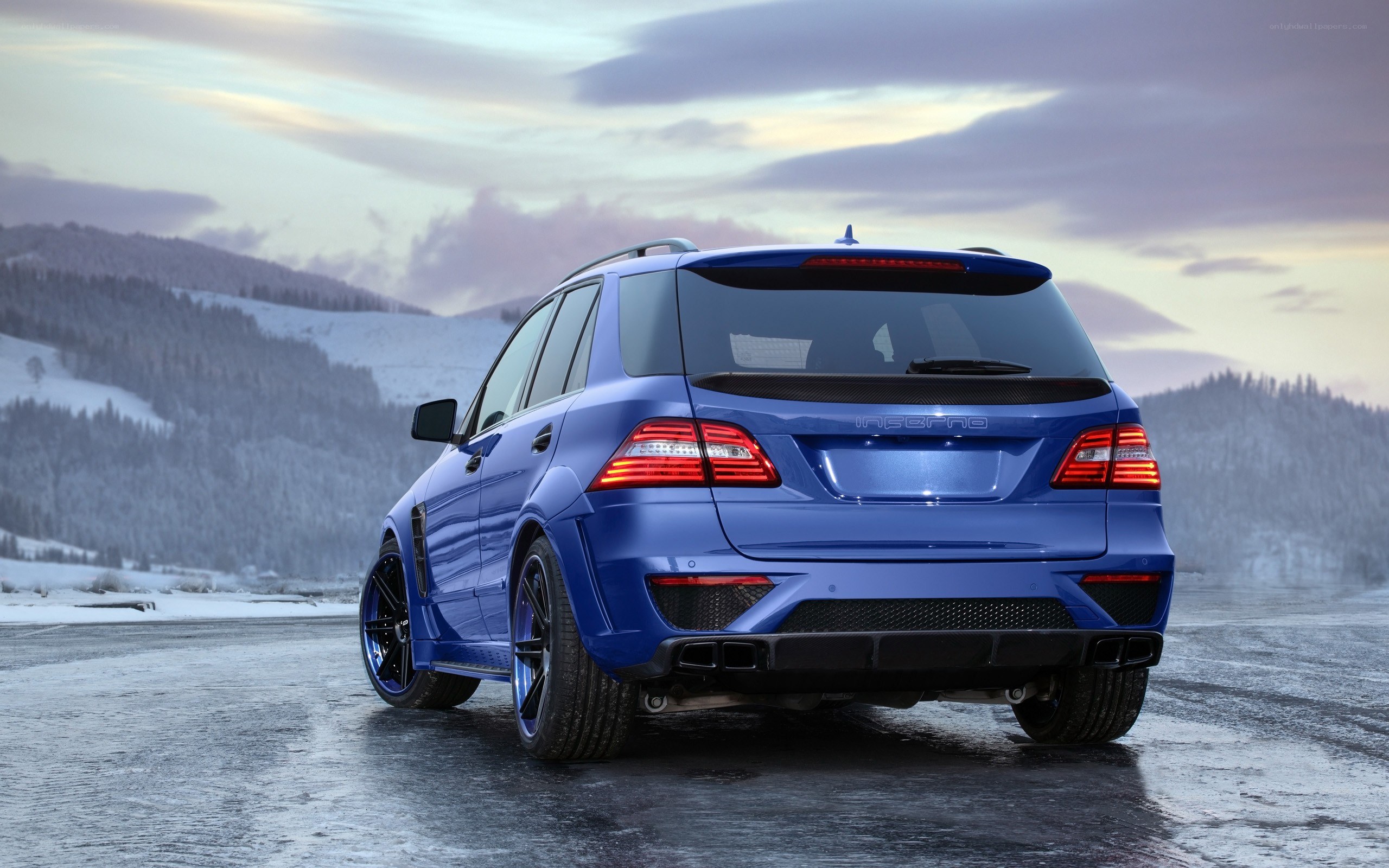 Blue SUV in snowy landscape