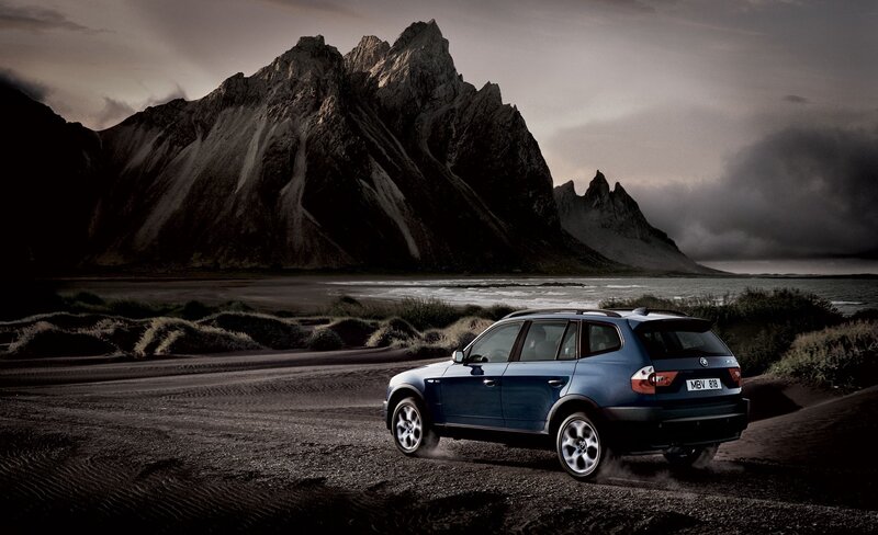 Blue SUV on a rugged beach