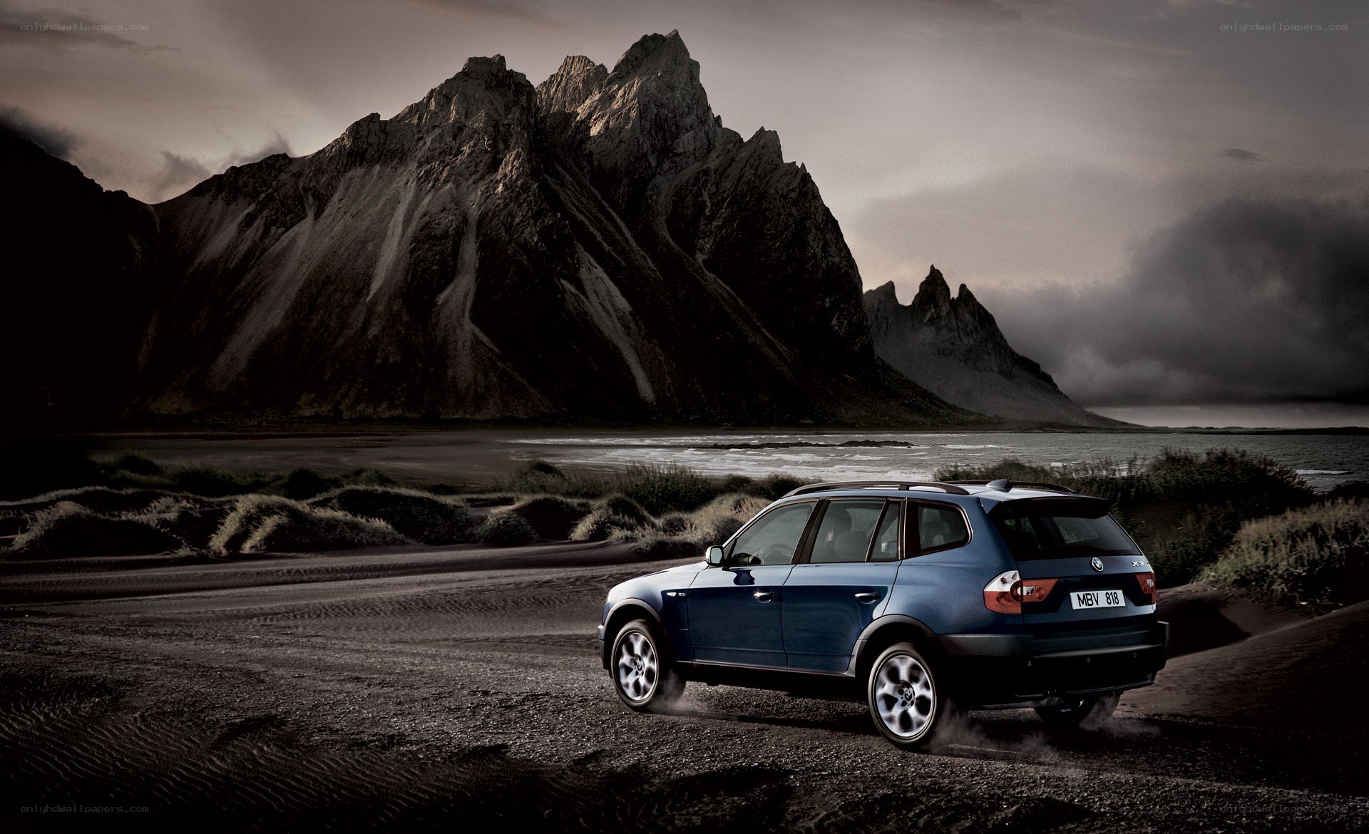 Blue SUV on a rugged beach