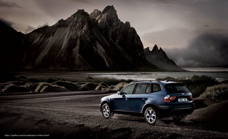 Blue SUV on a rugged coast