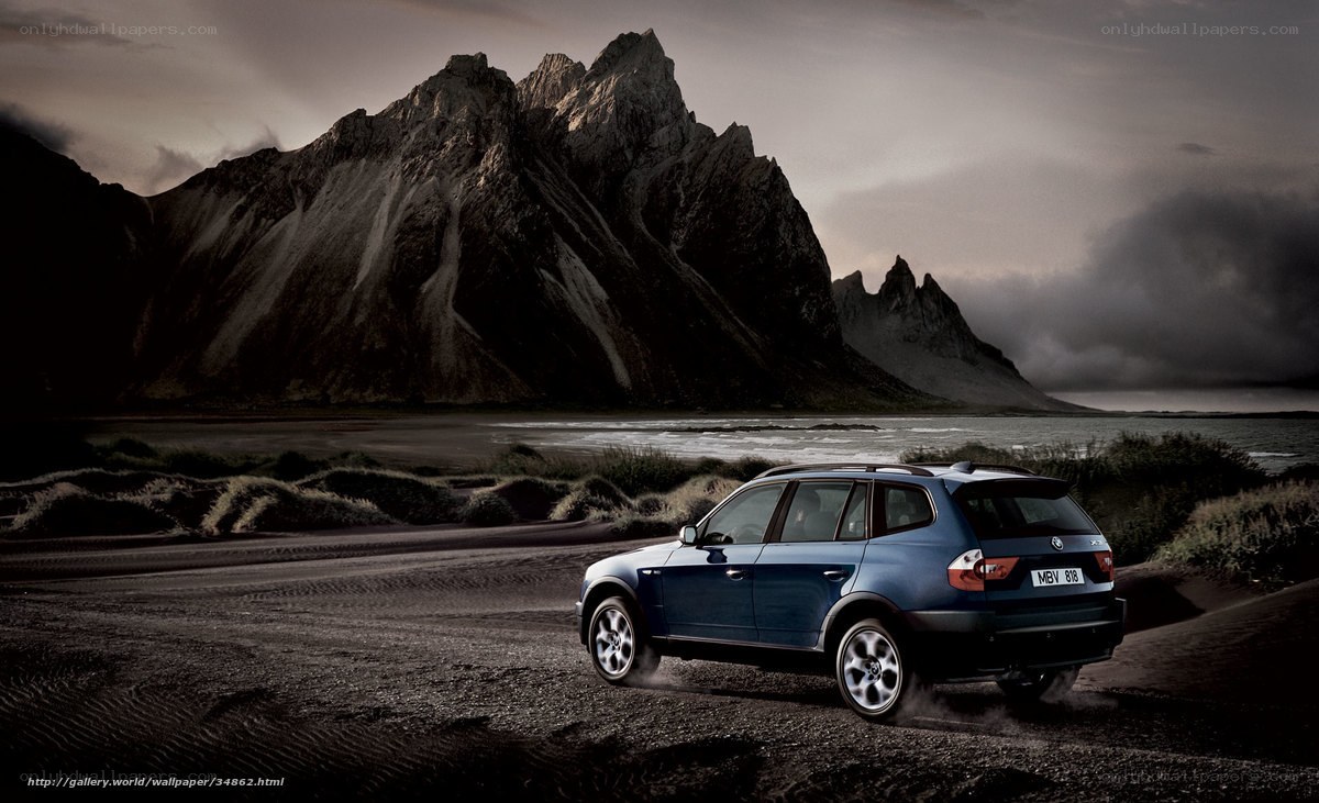 Blue SUV on a rugged coast