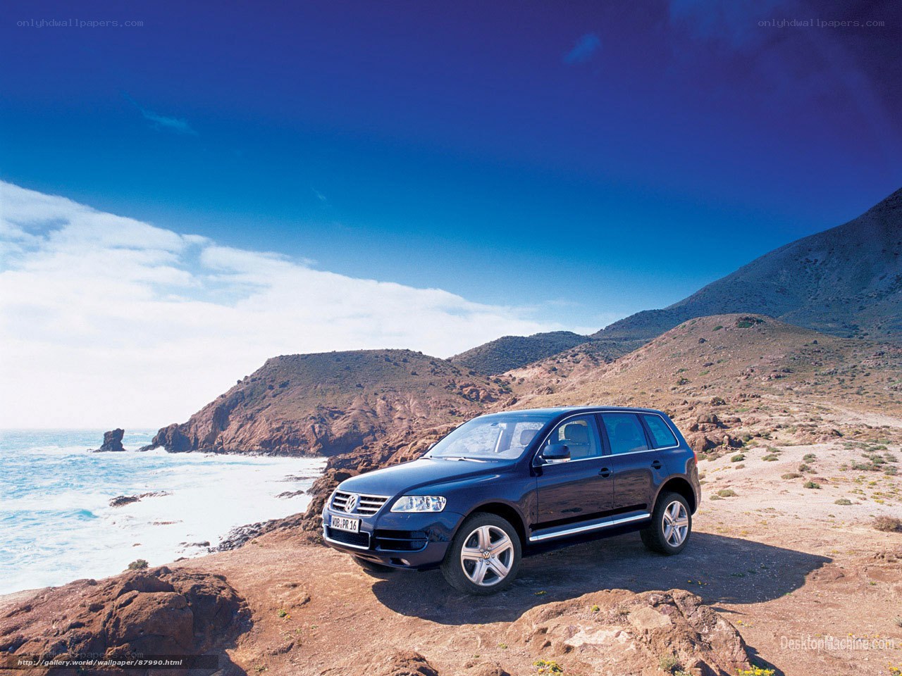 Blue SUV on coastal cliff
