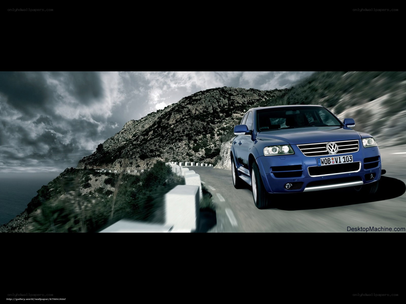 Blue SUV on coastal road