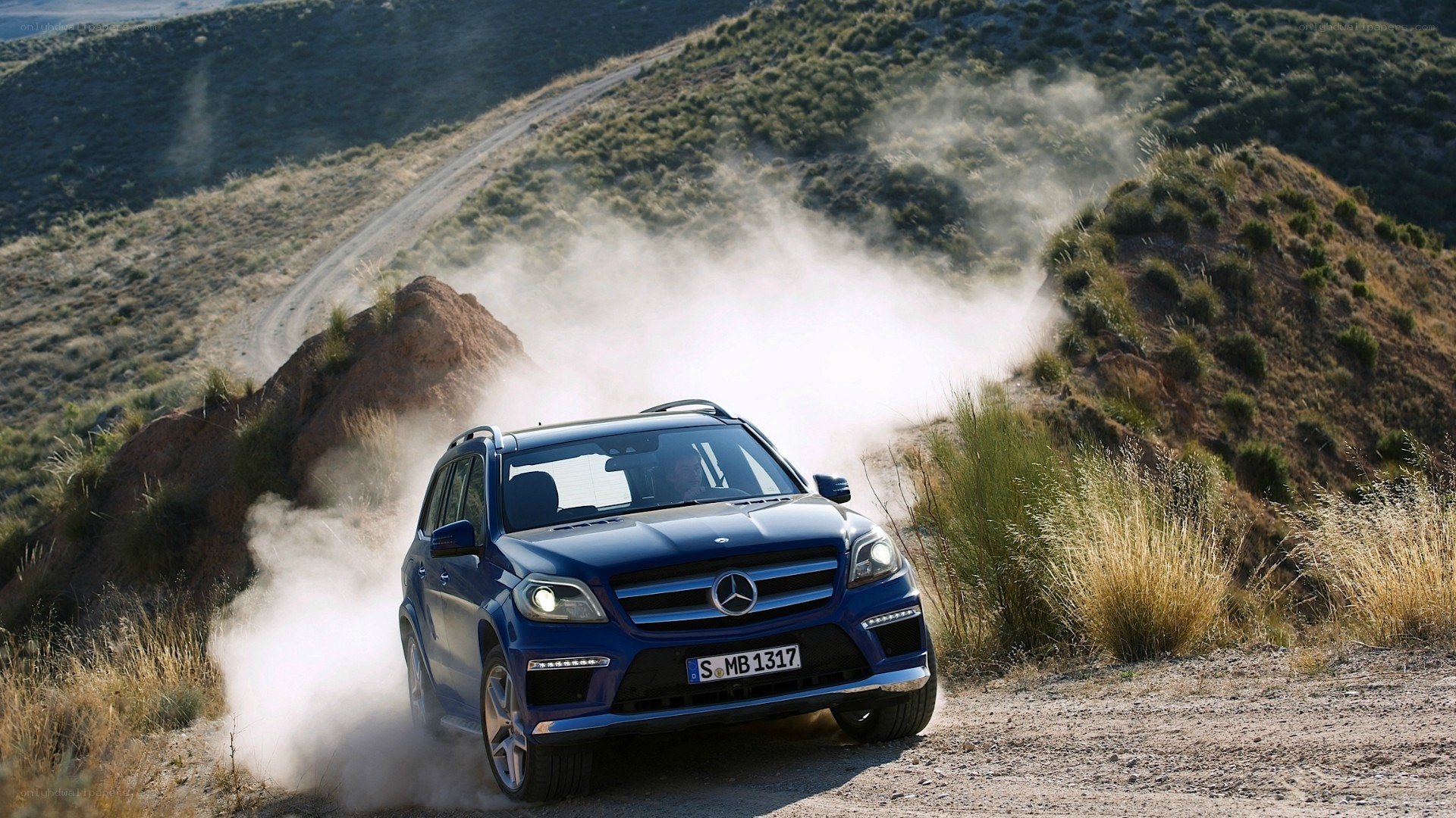Blue SUV on dusty trail
