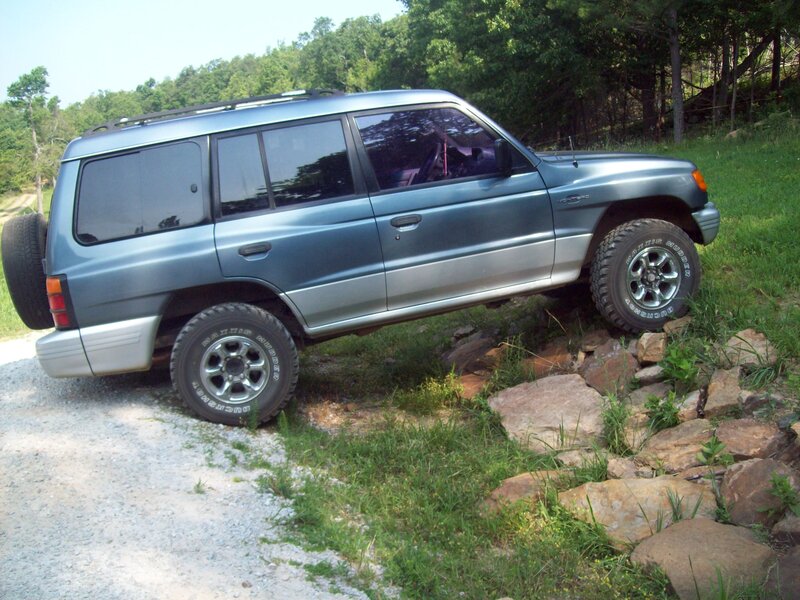 Blue SUV on Rocks