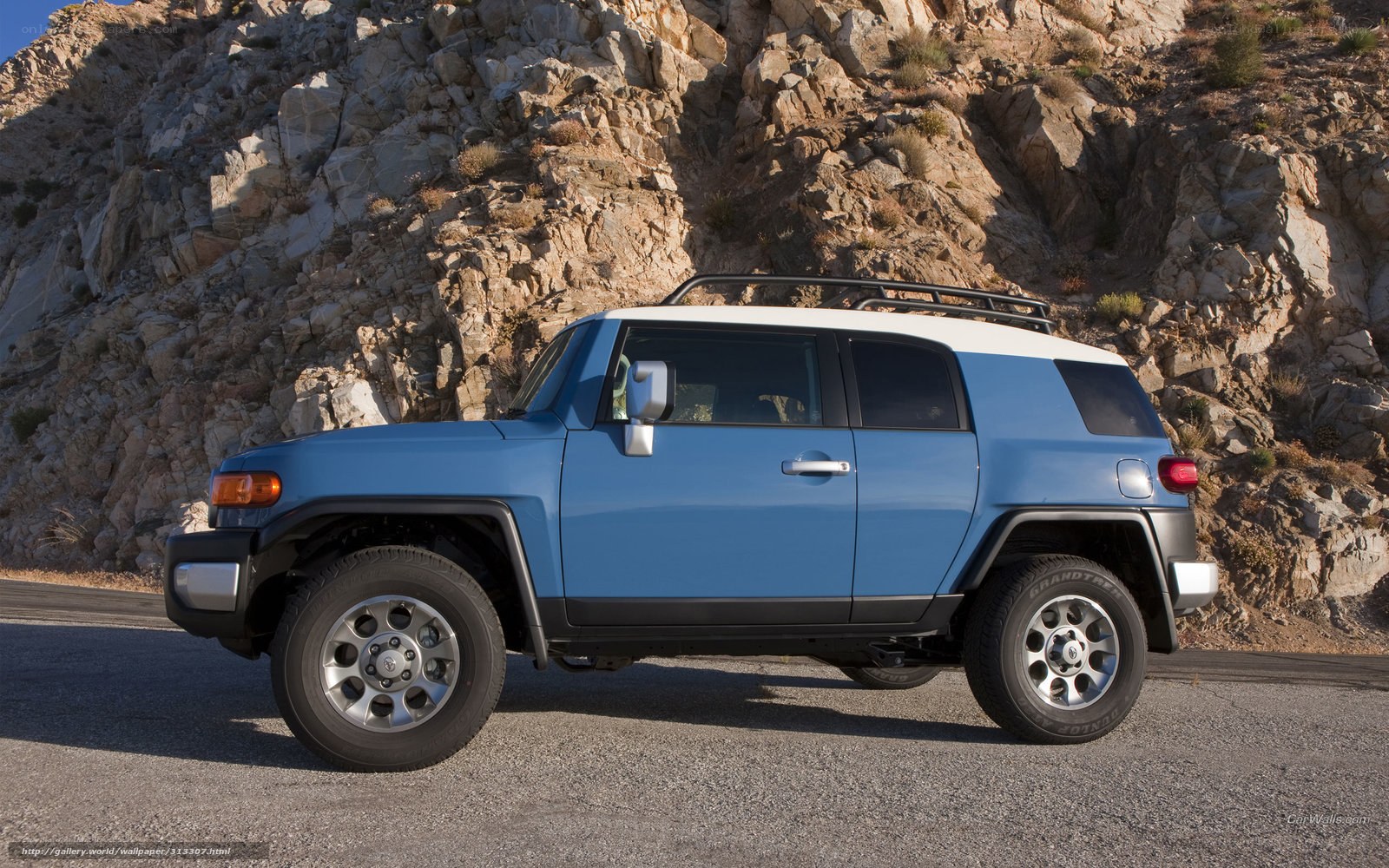 blue suv on rocky road