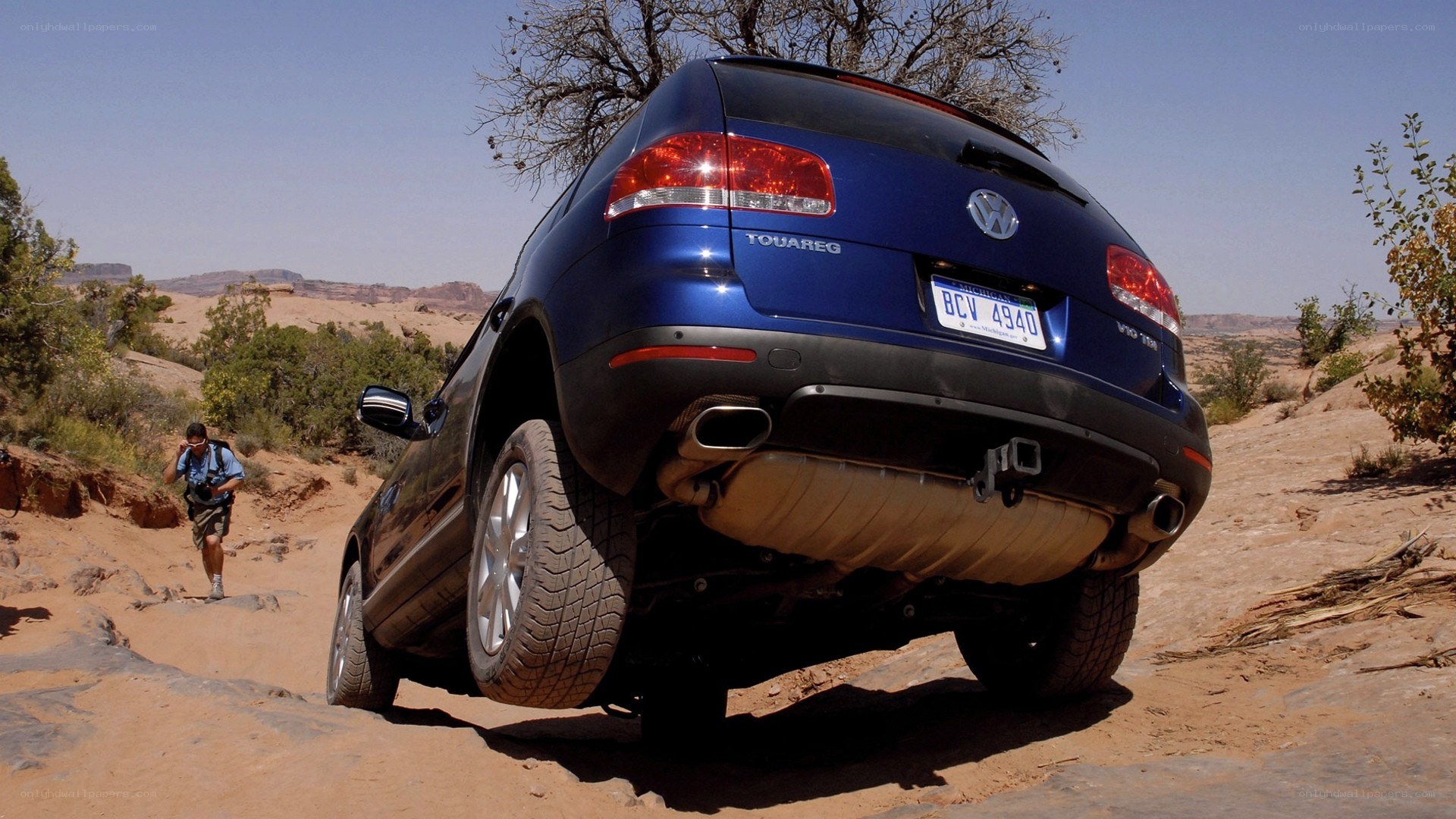 Blue SUV on rocky trail