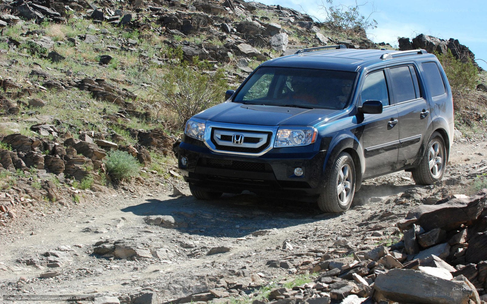 blue suv on rocky trail