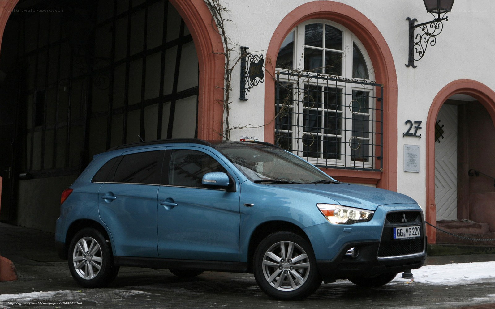 Blue SUV parked in front of building