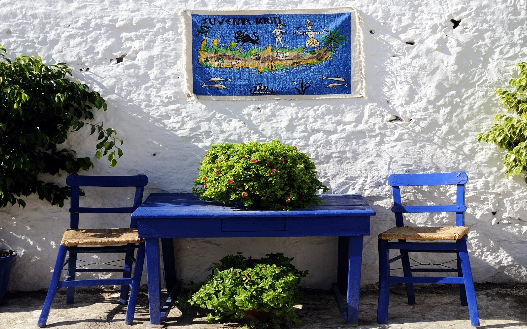 Blue table and chairs by white wall