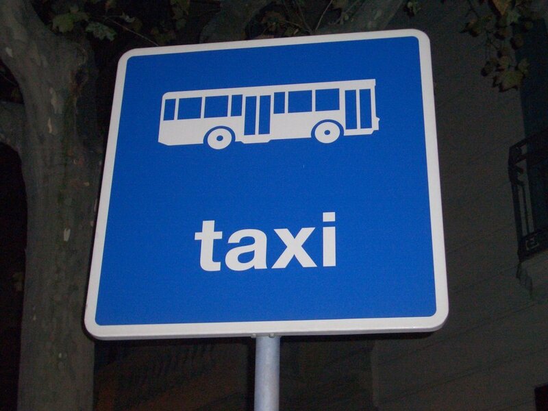 blue taxi sign at night