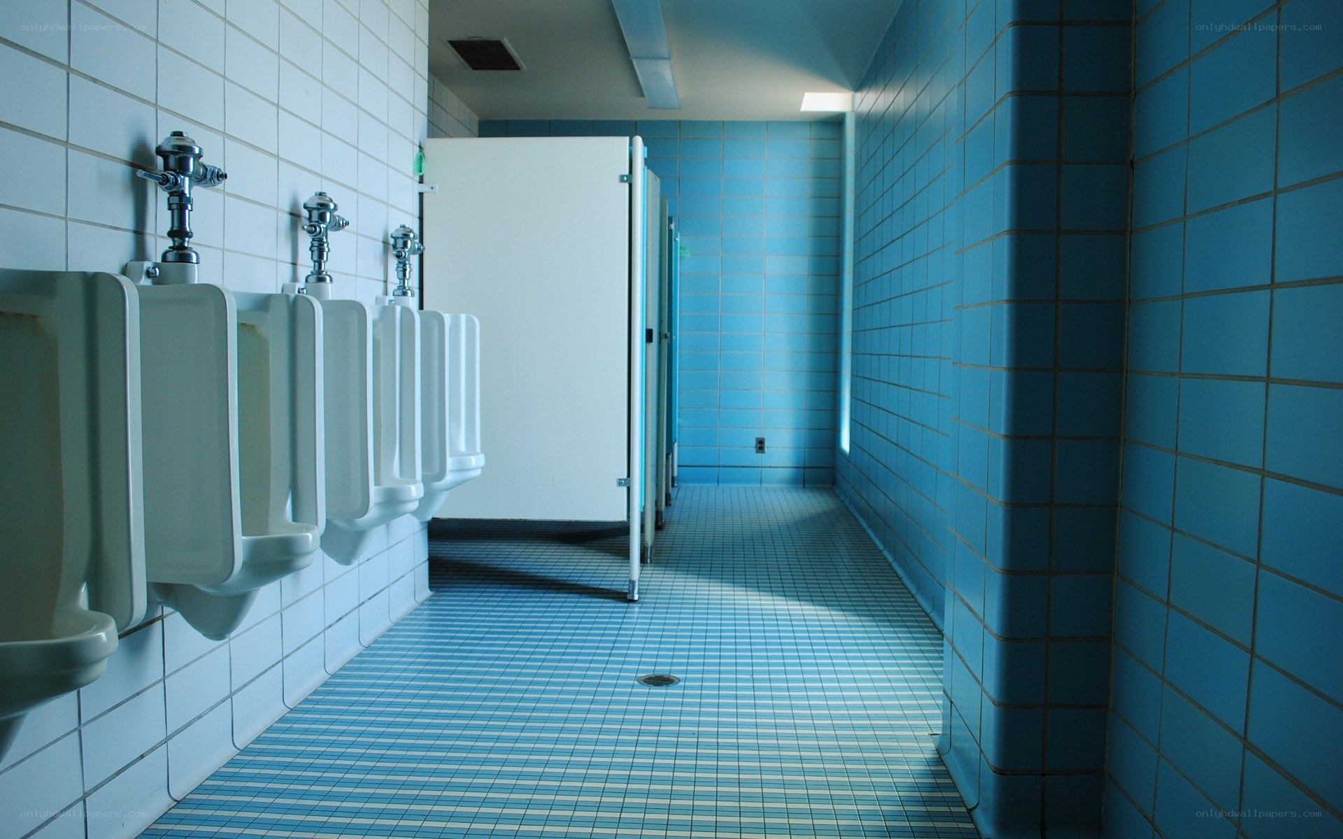 Blue-tiled men's restroom