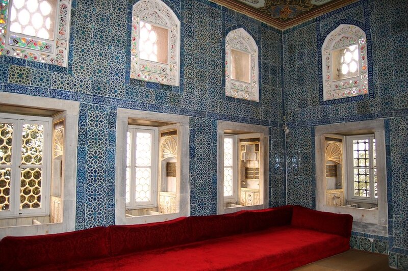 Blue-tiled room with red sofa