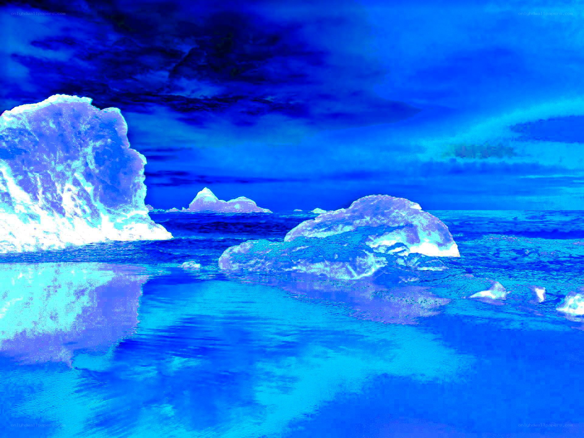Blue-toned icebergs in ocean