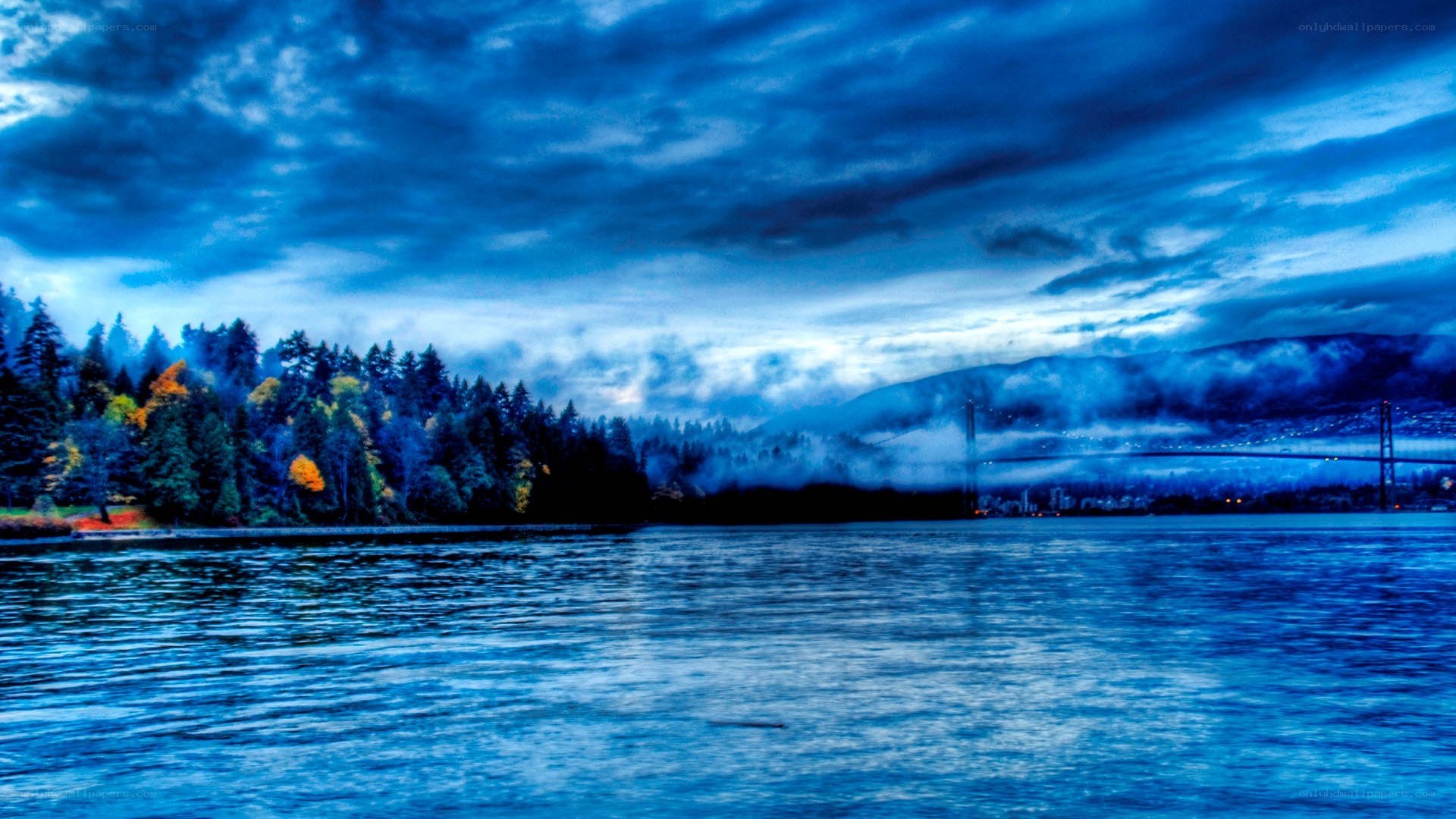 Blue-toned lake with bridge