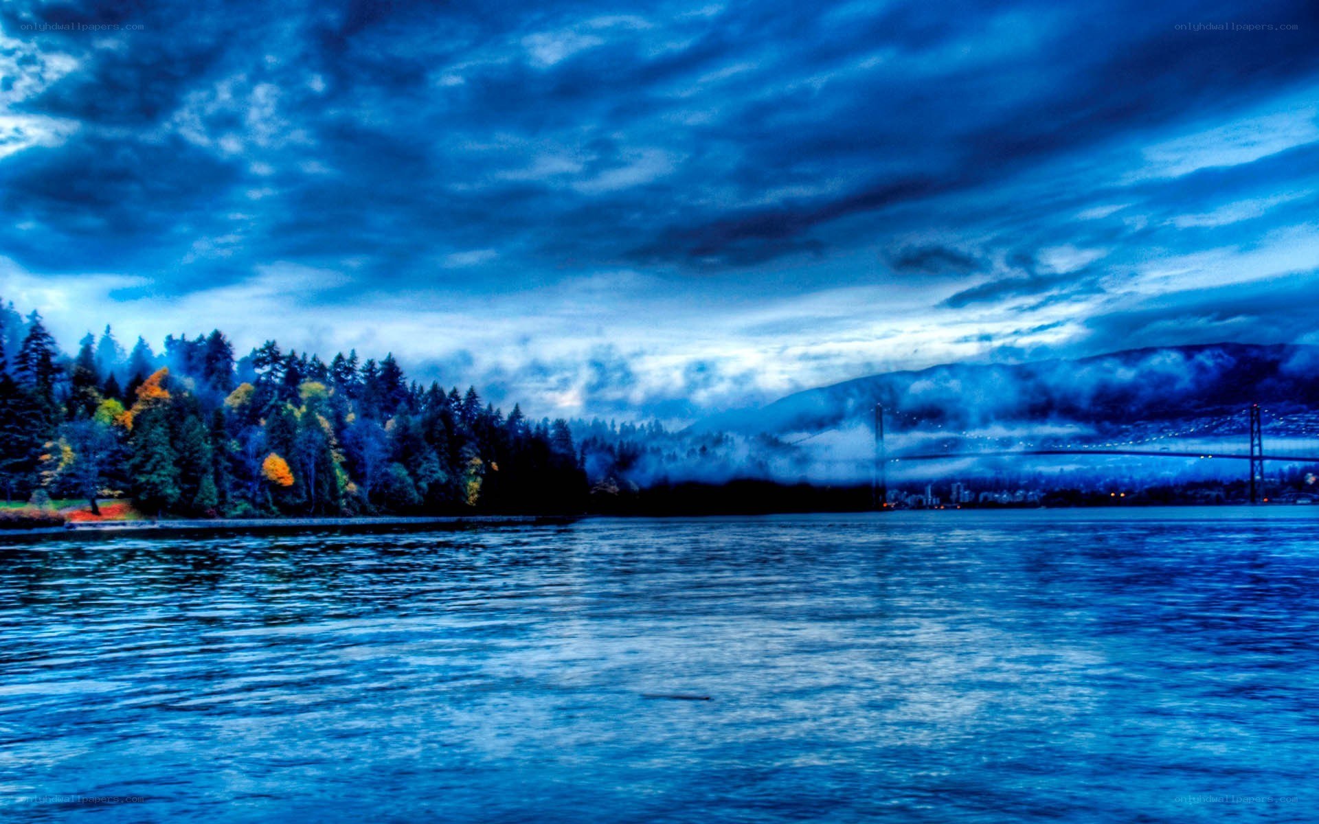 Blue-toned lake with bridge
