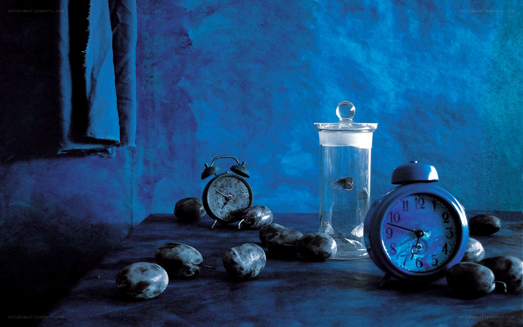 Blue-toned still life with clocks