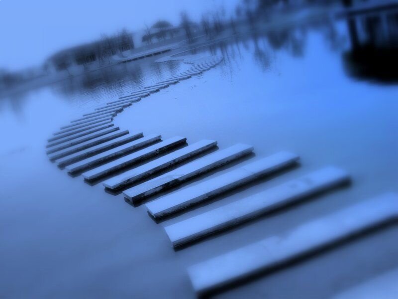 Blue-toned walkway over water
