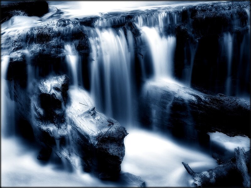 Blue-toned waterfall cascade