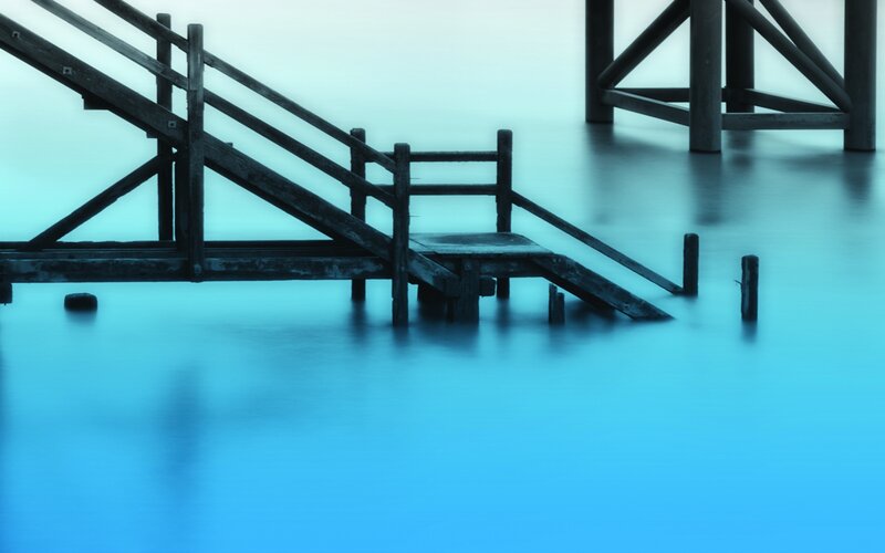 Blue-toned wooden pier structure
