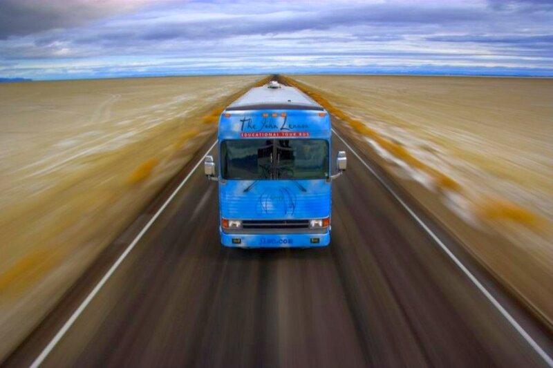 blue tour bus on open road