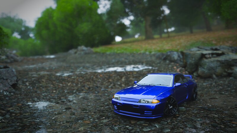 Blue Toy Car on Rocks