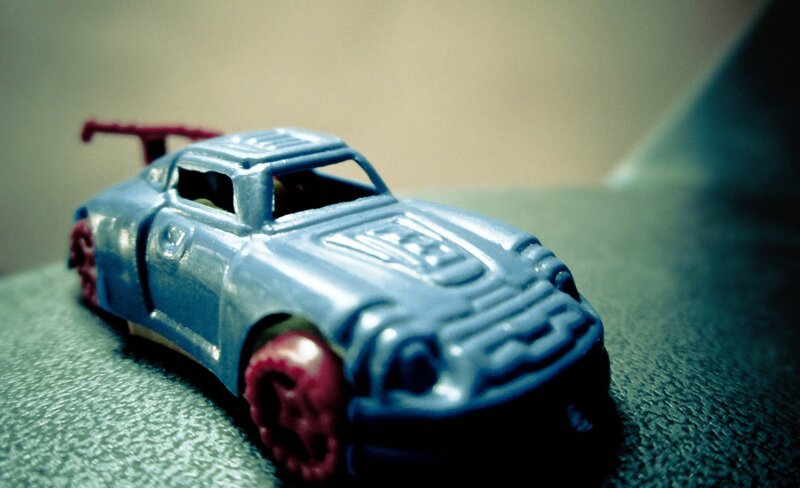 blue toy car with red wheels
