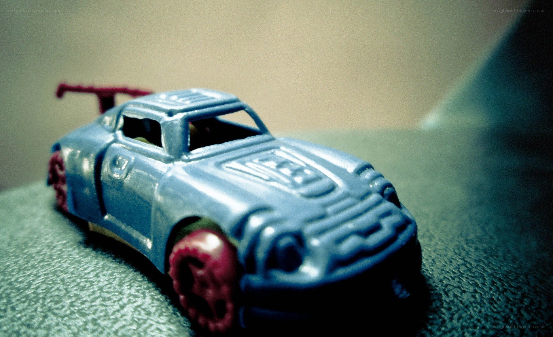 blue toy car with red wheels