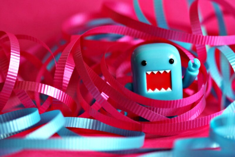 Blue Toy Figure in Ribbons