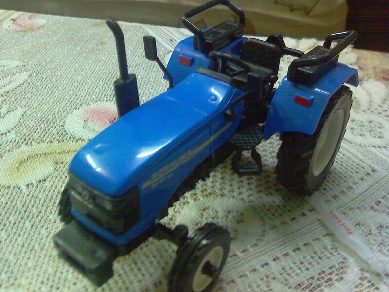 blue toy tractor on table