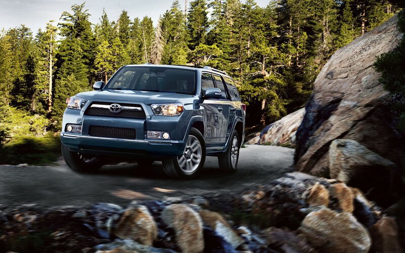 Blue Toyota 4Runner on forest road
