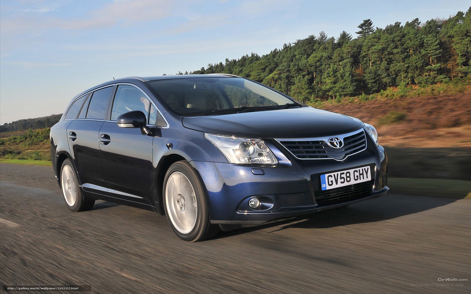 blue toyota avensis in motion