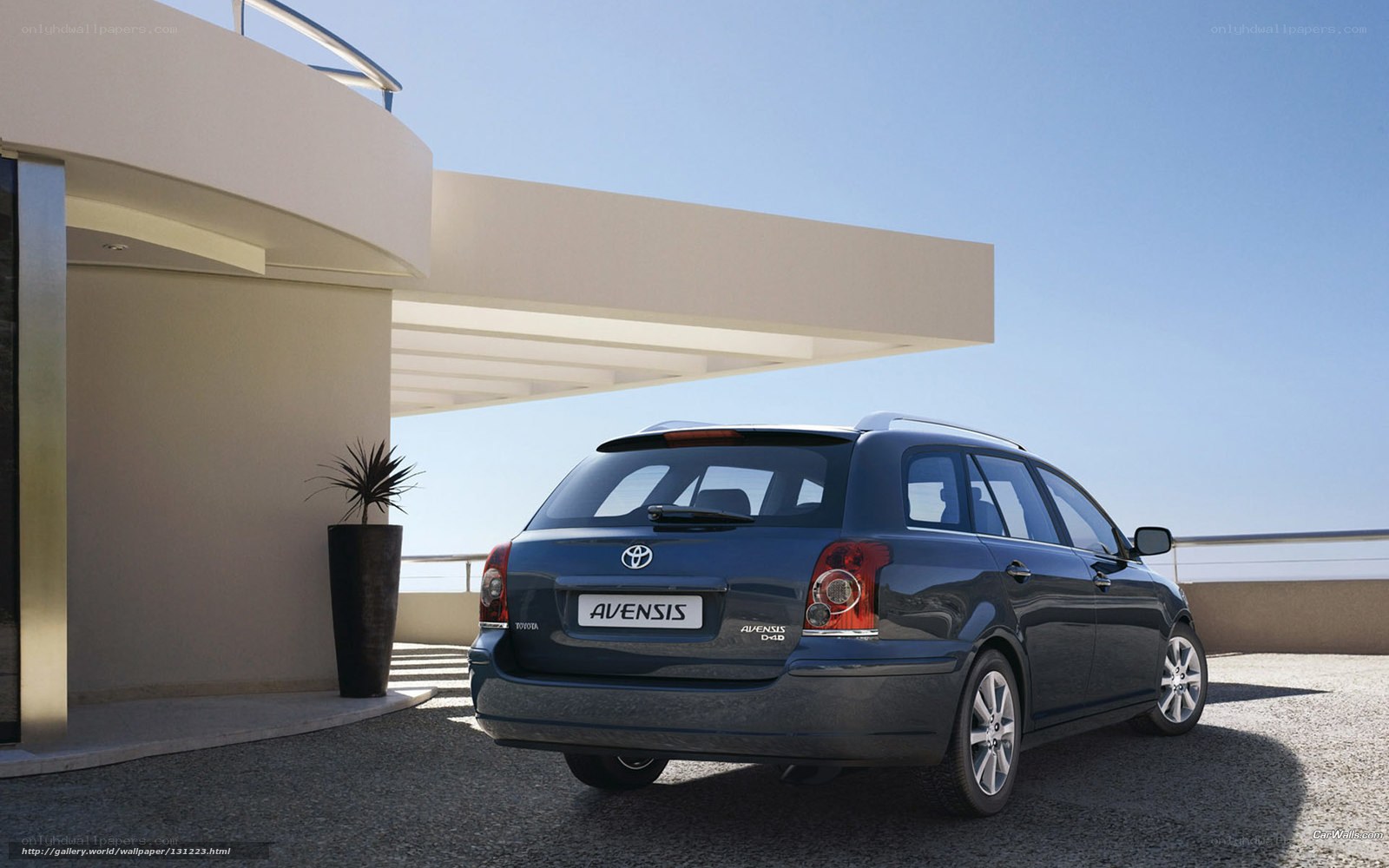 Blue Toyota Avensis parked outside