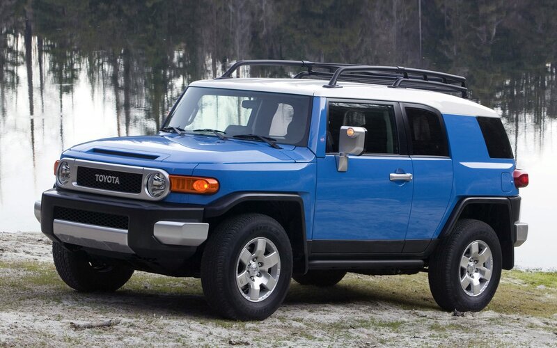 Blue Toyota FJ Cruiser by a lake