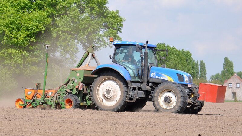 Blue Tractor Plowing Field — Active