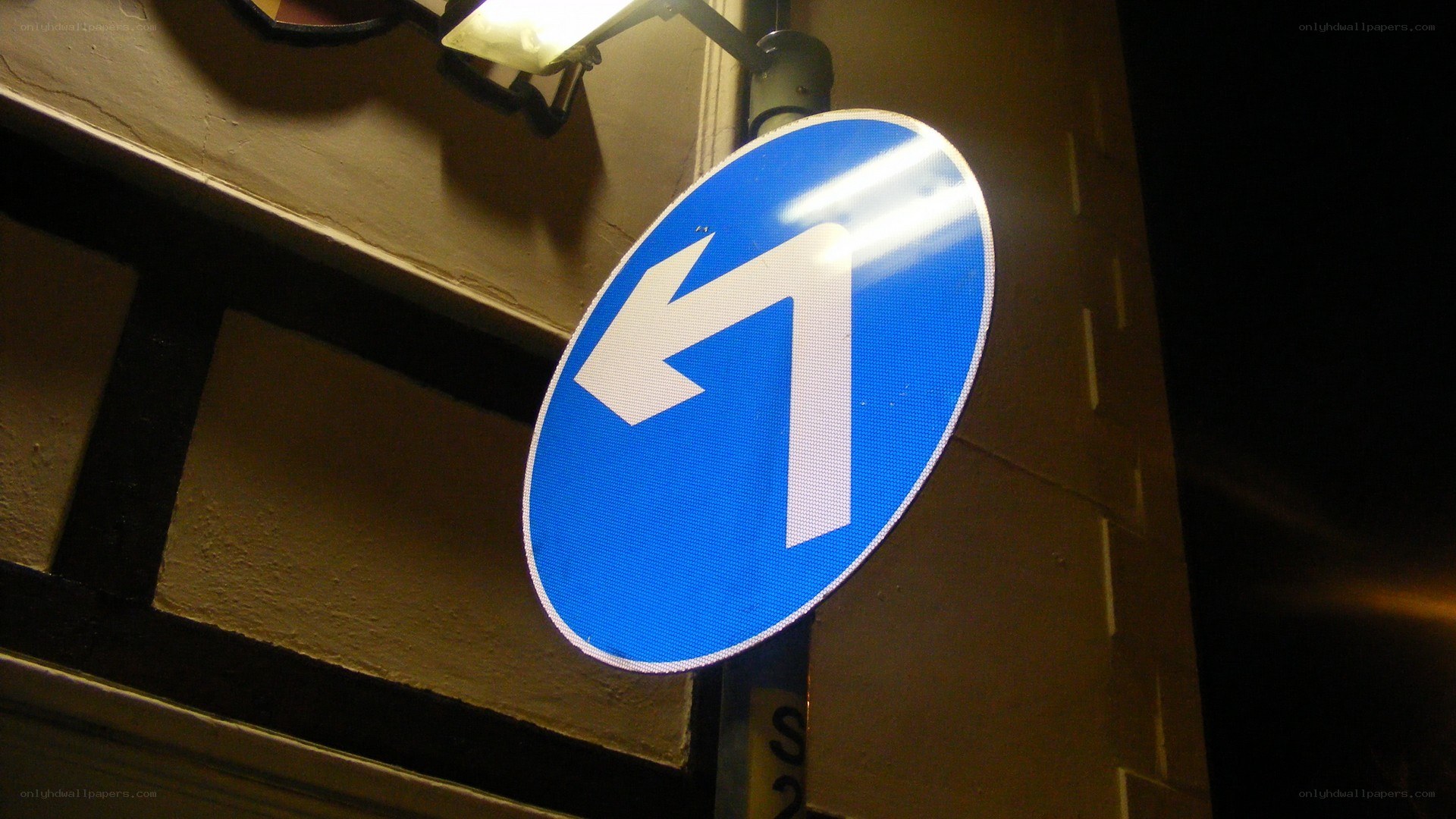 blue traffic sign at night