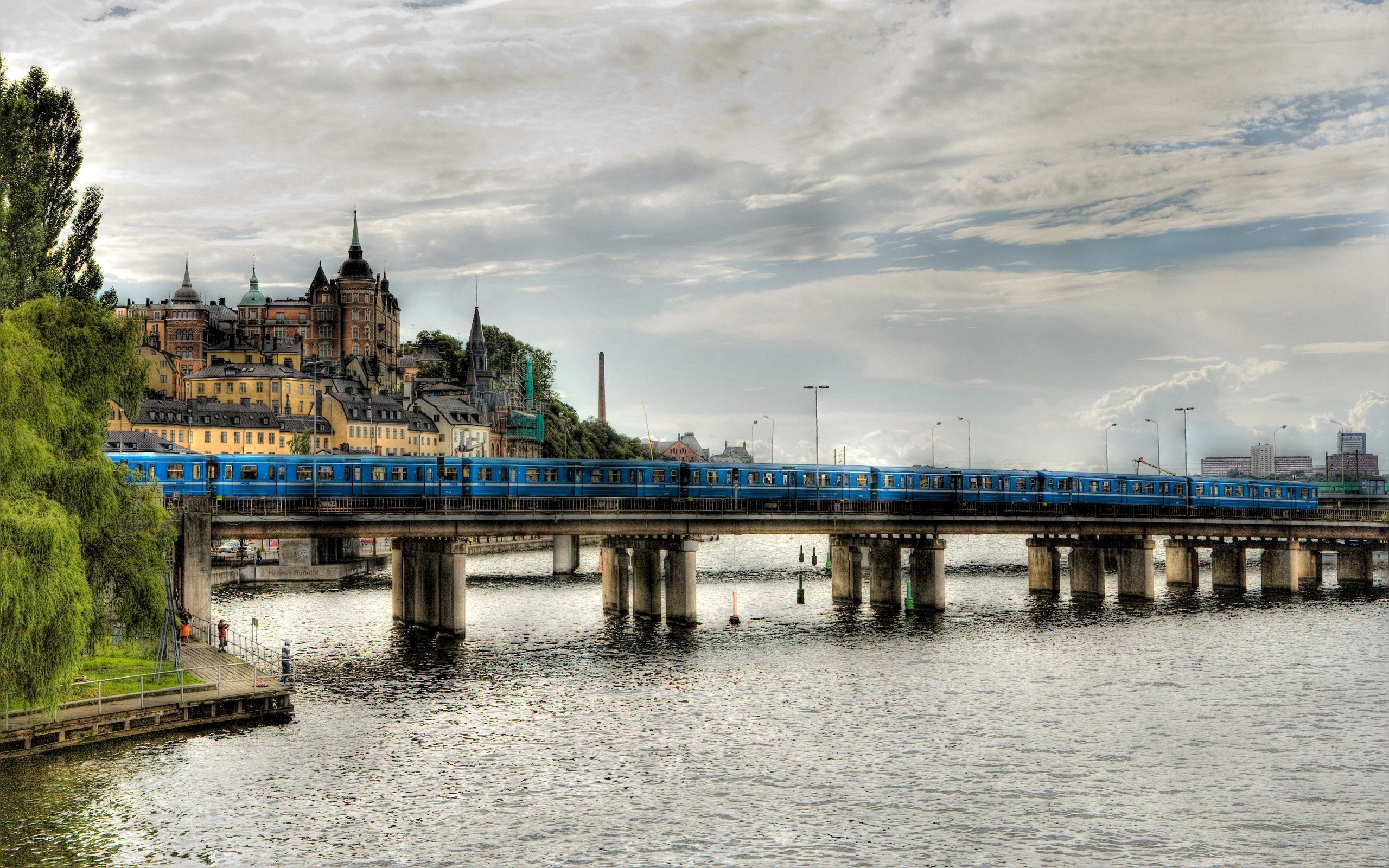 Blue train crossing bridge