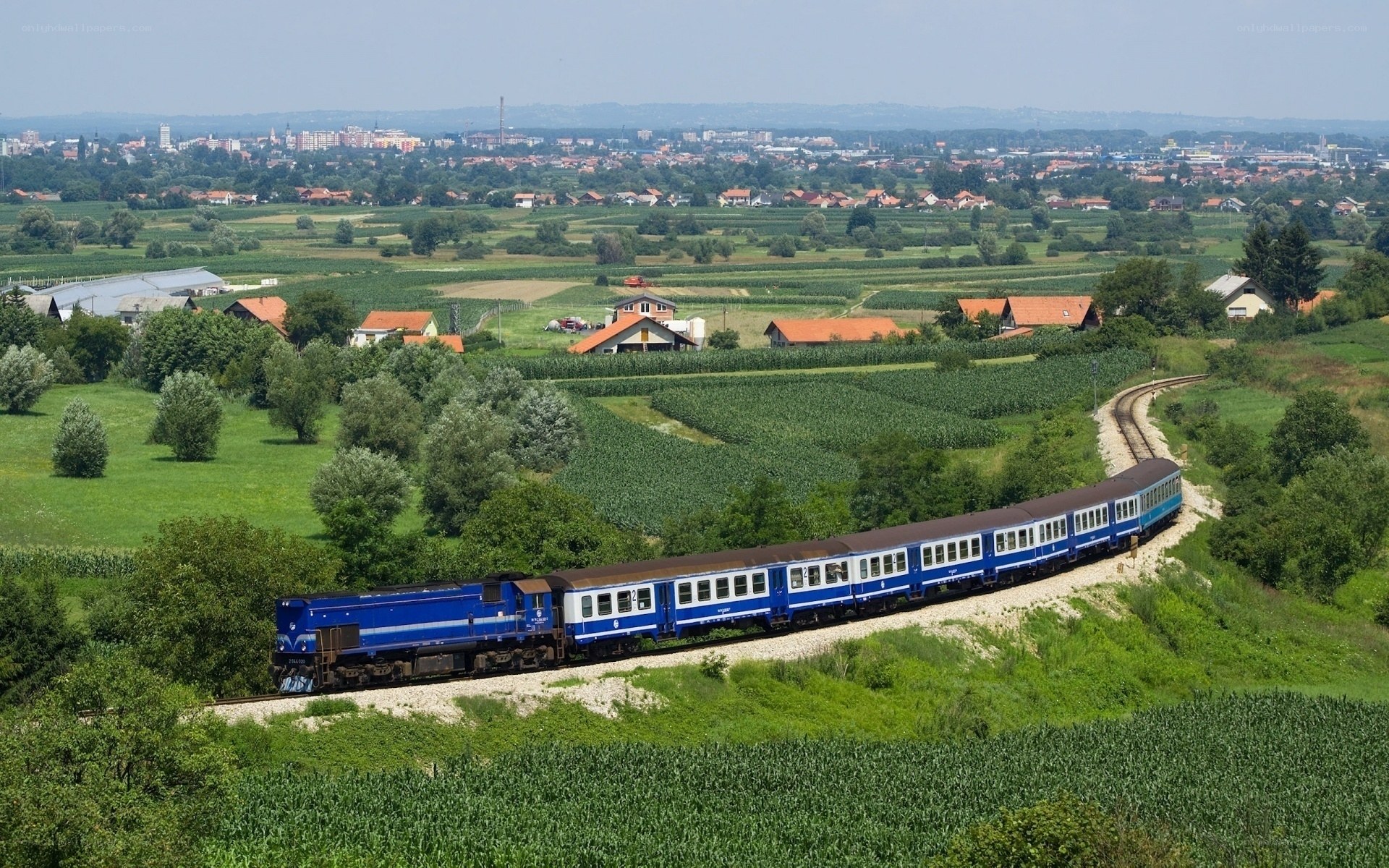 Blue train in rural landscape