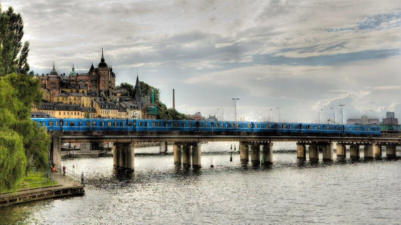 Blue Train on Bridge — Dramatic, Afternoon