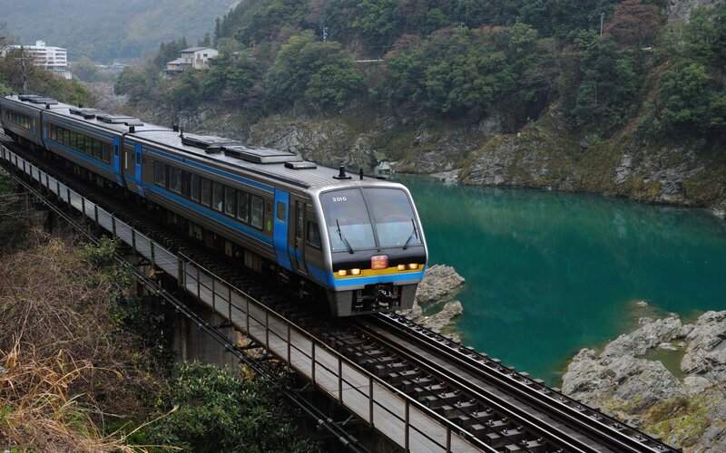 Blue Train on Bridge — Green, Serene