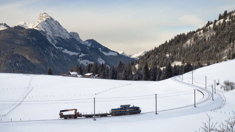 Blue Train on Snowy Track