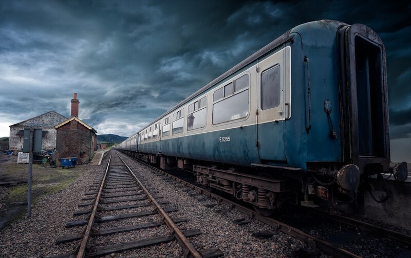 Blue Train on Tracks — Dramatic, Afternoon
